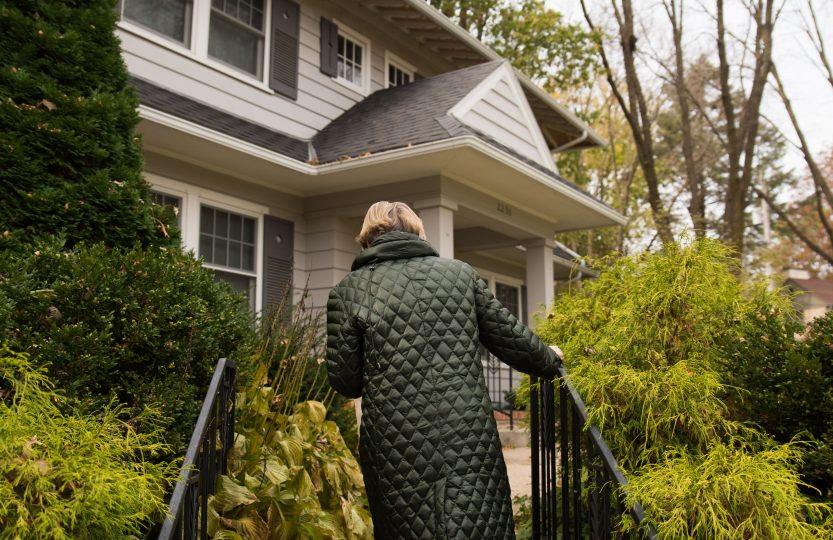Bate treks up the steep steps of a nearby home.