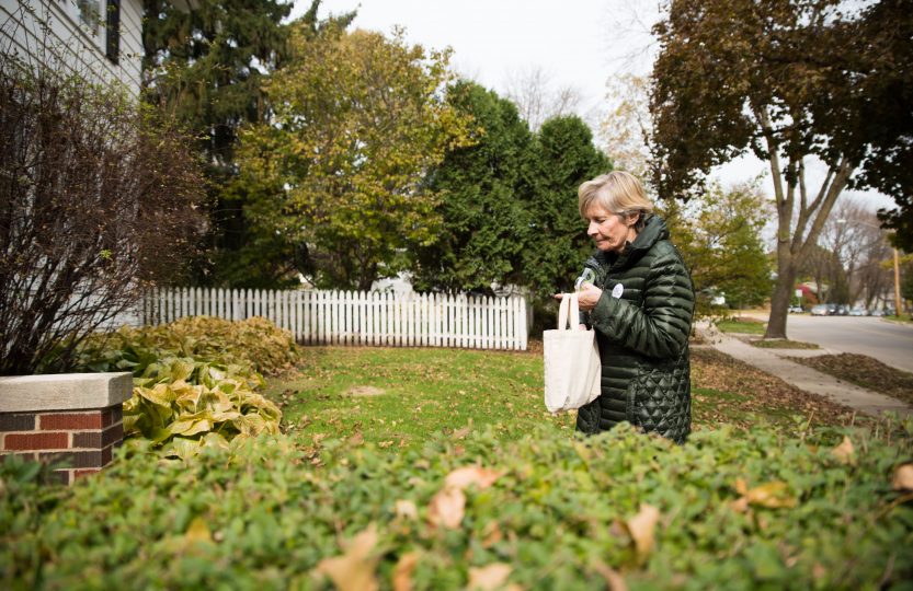 Bate carries a small canvas bag that holds hundreds of slips of blue paper and several rolls of tape.
