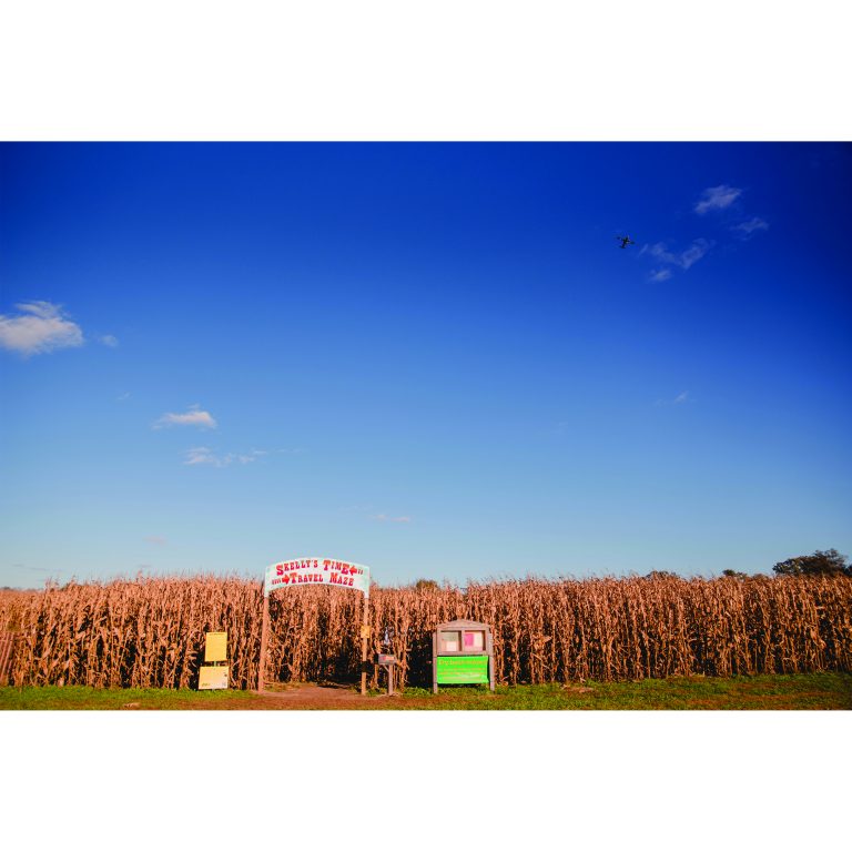 A plane flies over the entrance of Skelly’s Time Travel Maze.